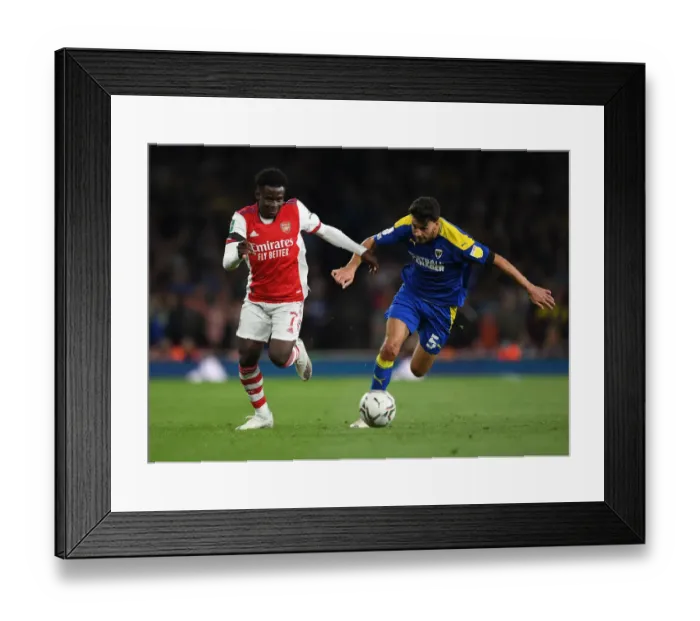 Framed Print : Saka vs. Nightingale: Arsenal's Star Forward Meets Wimbledon's Defender in Carabao Cup Battle