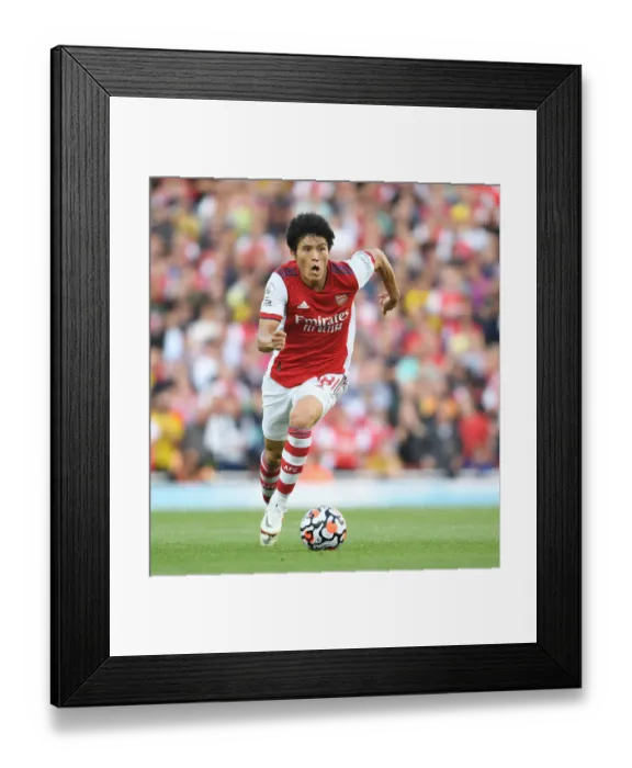 Framed Print : Arsenal's Tomiyasu in Action: Premier League Clash Against Tottenham at Emirates Stadium