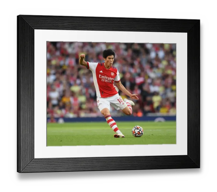 Framed Print : Arsenal's Tomiyasu Faces Off Against Tottenham in Premier League Clash