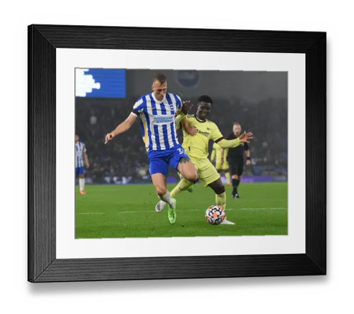 Framed Print : Bukayo Saka vs Dan Burn: Intense Battle in Brighton & Hove Albion vs Arsenal Premier League Clash