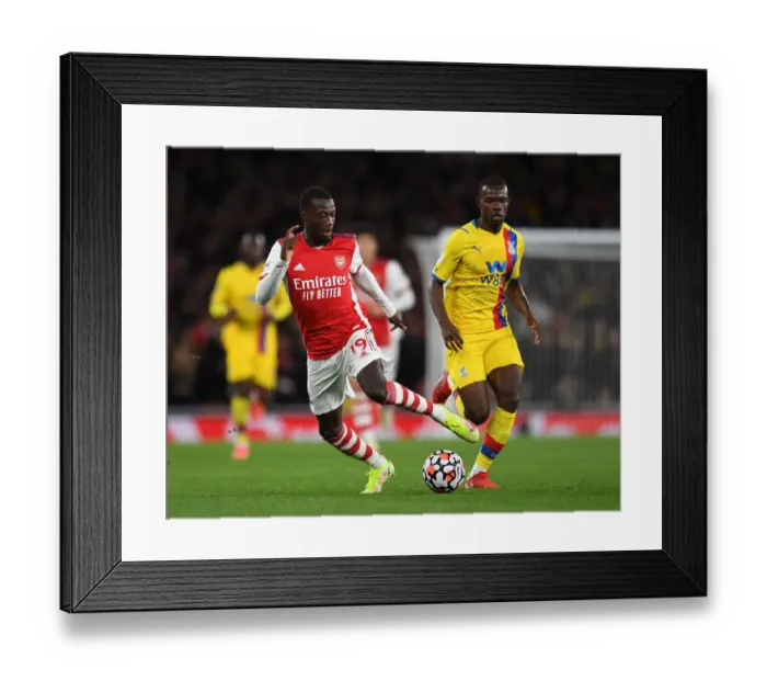 Framed Print : Arsenal's Pepe Clashes with Palace's Mitchell in Premier League Showdown