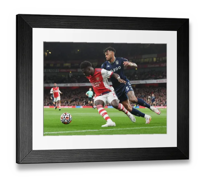 Framed Print : Arsenal's Bukayo Saka Faces Off Against Aston Villa's Tyrone Mings in Premier League Showdown Framed Print : Arsenal's Bukayo Saka Faces Off Against Aston Villa's Tyrone Mings in Premier League Showdown
