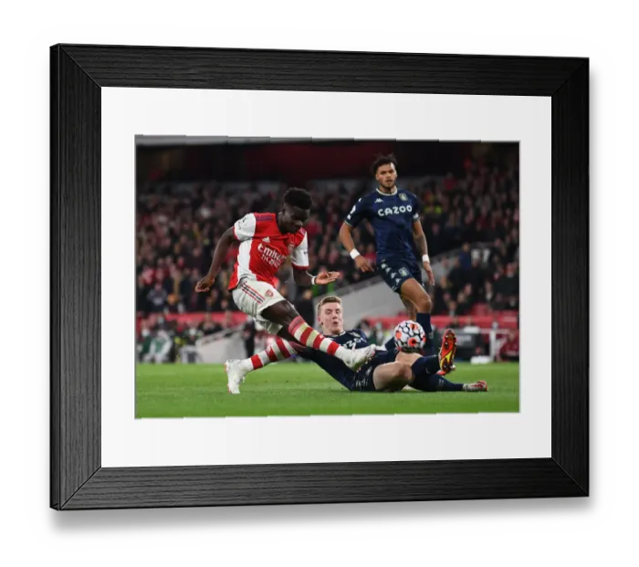 Framed Print : Arsenal's Bukayo Saka Faces Off Against Matt Targett in Intense Arsenal v Aston Villa Clash Framed Print : Arsenal's Bukayo Saka Faces Off Against Matt Targett in Intense Arsenal v Aston Villa Clash