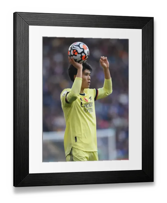 Framed Print : Arsenal's Tomiyasu Stands Strong: Premier League Battle vs Leicester
