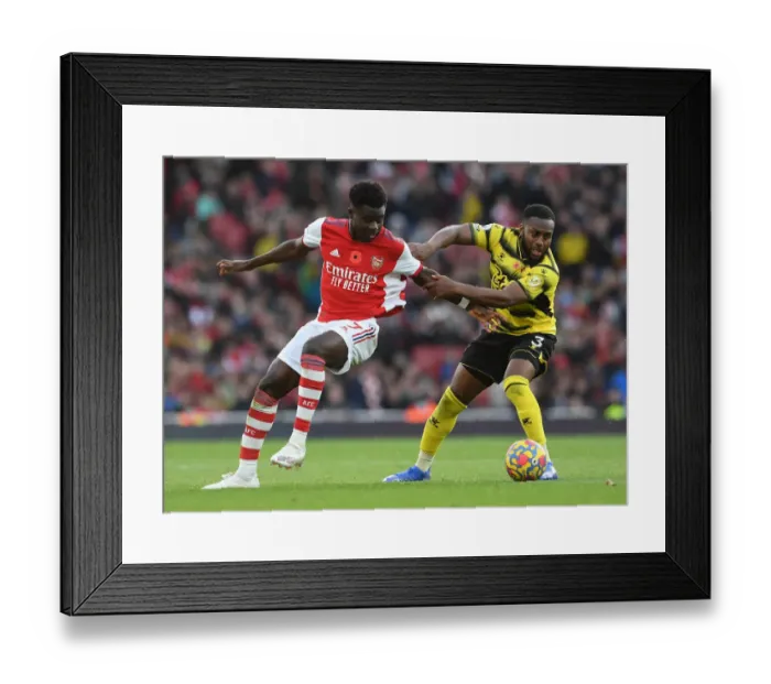 Framed Print : Arsenal's Bukayo Saka Takes on Watford's Danny Rose in Premier League Clash