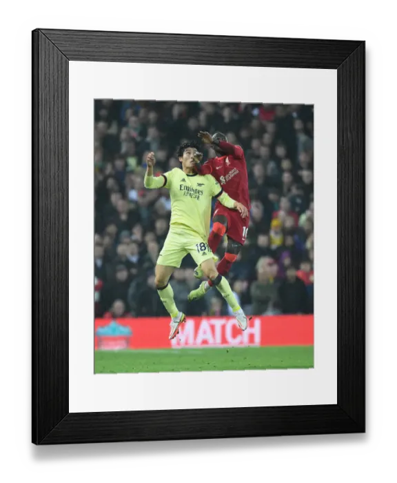 Framed Print : Clash at Anfield: Tomiyasu vs. Mane - Intense Rivalry Erupts in Premier League Football Framed Print : Clash at Anfield: Tomiyasu vs. Mane - Intense Rivalry Erupts in Premier League Football