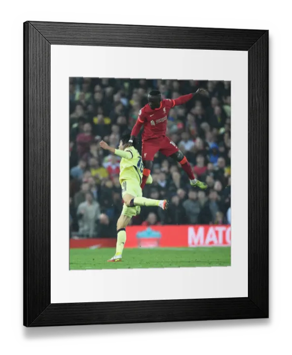 Framed Print : Clash at Anfield: Tomiyasu Fouls Mane - Intense Rivalry in Premier League Football