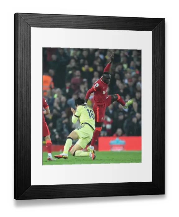 Framed Print : Clash at Anfield: Liverpool vs. Arsenal - Tomiyasu Fouls Mane Framed Print : Clash at Anfield: Liverpool vs. Arsenal - Tomiyasu Fouls Mane