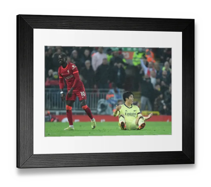 Framed Print : Tomiyasu vs. Mane: A Fiery Rivalry - Liverpool vs. Arsenal at Anfield Framed Print : Tomiyasu vs. Mane: A Fiery Rivalry - Liverpool vs. Arsenal at Anfield