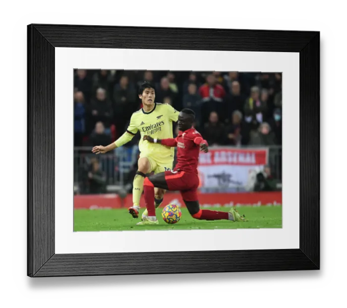 Framed Print : Clash at Anfield: Sadio Mane vs. Takehiro Tomiyasu in the Premier League Showdown between Liverpool and Arsenal