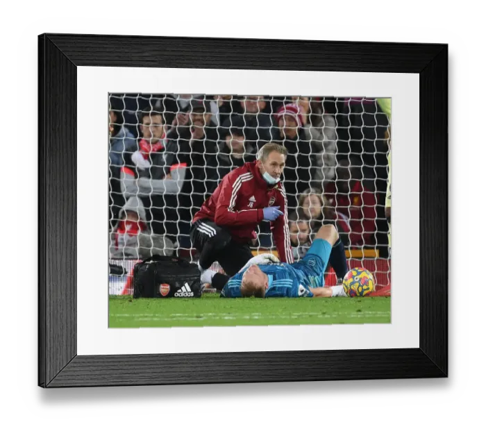 Framed Print : Arsenal's Ramsdale Receives Medical Attention Amidst Intense Liverpool Clash