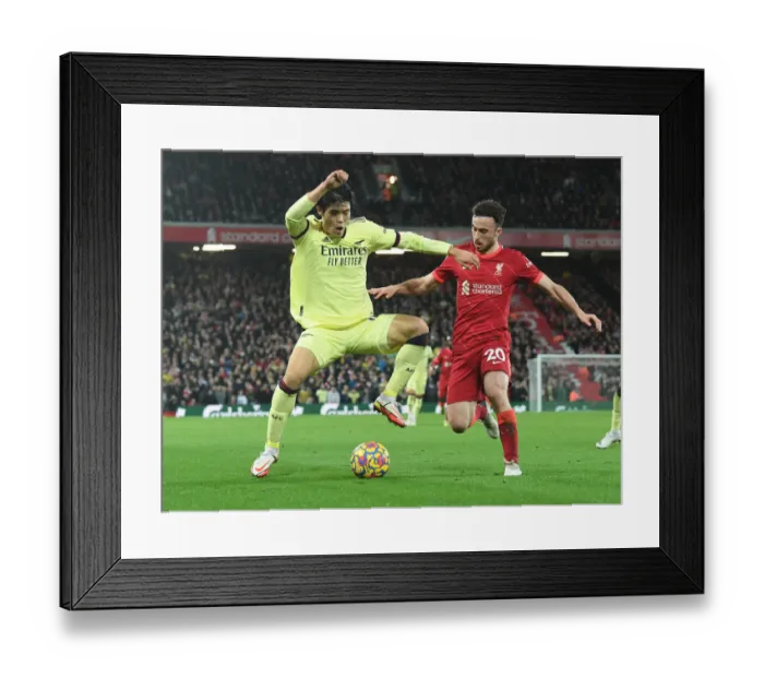 Framed Print : Clash at Anfield: Tomiyasu vs. Jota in the Premier League Showdown between Liverpool and Arsenal