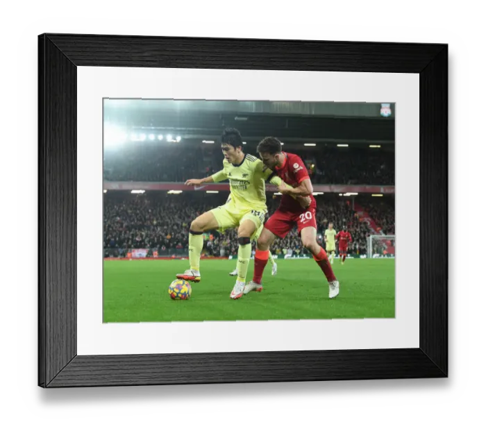 Framed Print : Tomiyasu vs. Jota: A Premier League Battle at Anfield Framed Print : Tomiyasu vs. Jota: A Premier League Battle at Anfield