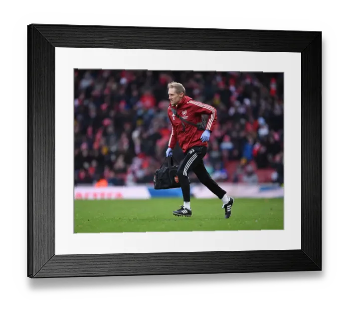 Framed Print : Arsenal Physio Jordan Reece Tending to Injured Player during Arsenal vs Newcastle United, Premier League 2021-22
