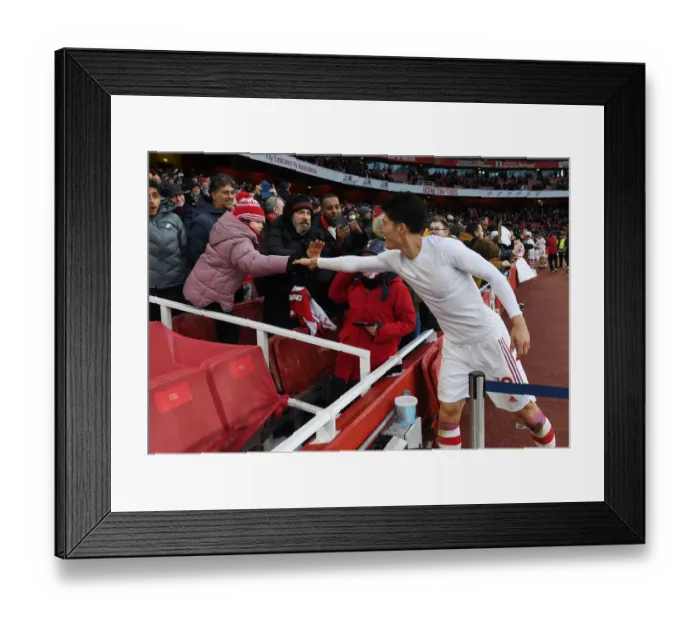Framed Print : Arsenal's Tomiyasu Delights Fan with Shirt Present after Newcastle Victory
