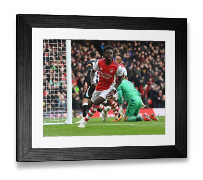 Framed Print : Saka Scores First: Arsenal's Triumph Over Newcastle United in the Premier League 2021-22