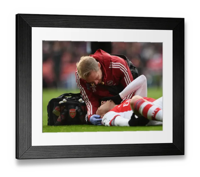 Framed Print : Arsenal's Gabriel Martinelli Receives Medical Attention during Arsenal vs Newcastle United (Premier League 2021-22)