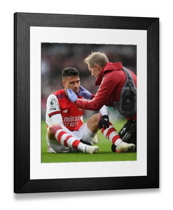 Framed Print : Arsenal's Gabriel Martinelli Receives Medical Attention During Arsenal vs Newcastle United (Premier League 2021-22)