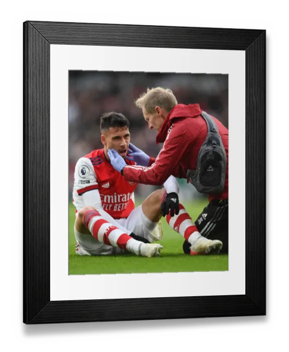 Framed Print : Arsenal's Gabriel Martinelli Receives Medical Attention During Arsenal vs Newcastle United (Premier League 2021-22)