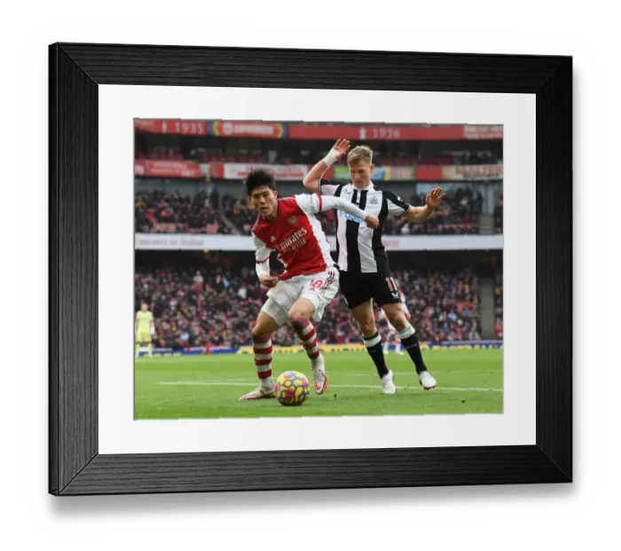 Framed Print : Arsenal vs Newcastle United: Tomiyasu Tangles with Ritchie in Premier League Clash