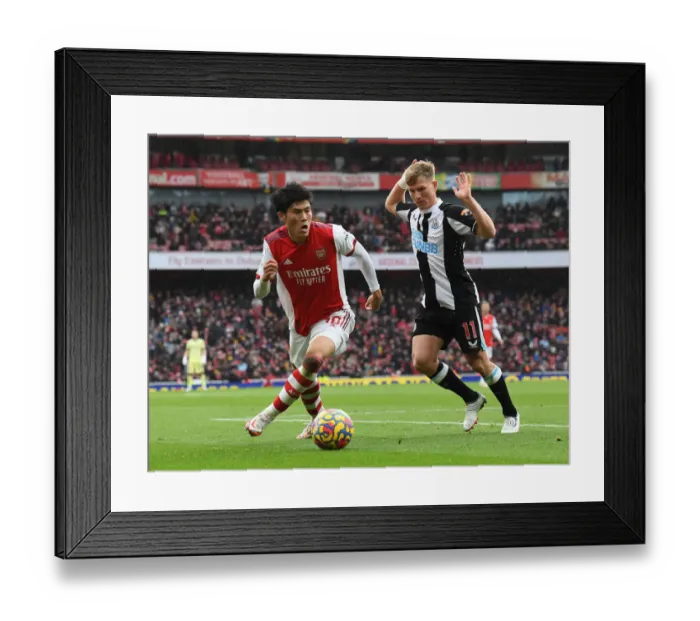 Framed Print : Tomiyasu vs Ritchie: A Battle of Wits in the Arsenal vs Newcastle Premier League Clash