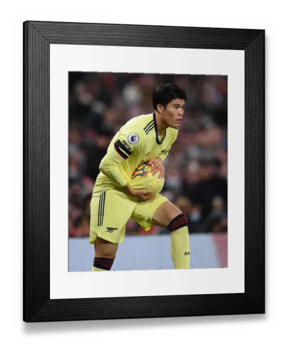 Framed Print : Tomiyasu vs Manchester United: Arsenal's Defender Stands Firm at Old Trafford