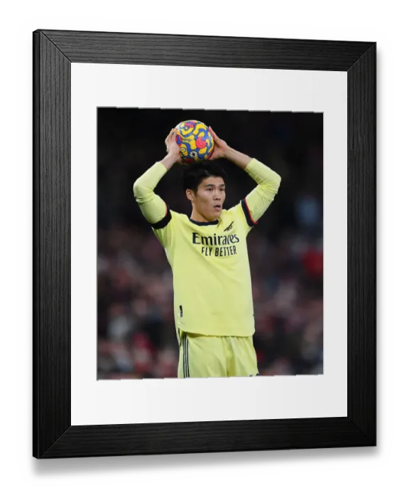 Framed Print : Tomiyasu Stands Firm: Arsenal's Defensive Hero at Old Trafford vs Manchester United (Premier League 2020-21)