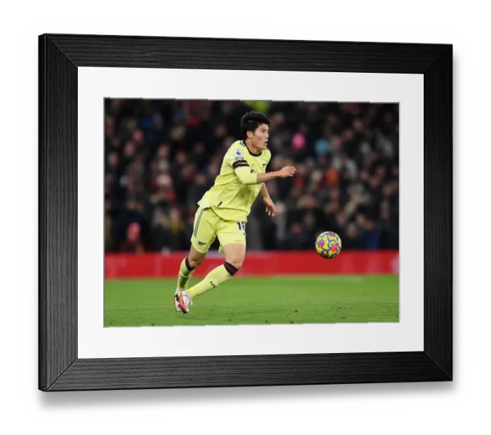 Framed Print : Tomiyasu vs Manchester United: Intense Premier League Showdown - Arsenal's Defender Faces Off Framed Print : Tomiyasu vs Manchester United: Intense Premier League Showdown - Arsenal's Defender Faces Off