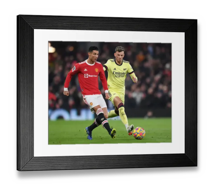 Framed Print : Clash at Old Trafford: Arsenal's White Holds Off Ronaldo in Manchester United vs Arsenal Premier League Showdown