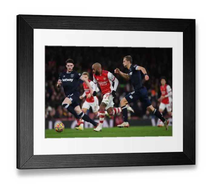 Framed Print : Arsenal's Lacazette Outmaneuvers Rice and Soucek in Intense Arsenal v West Ham United Clash (2021-22)