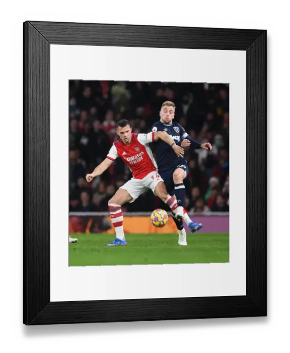 Framed Print : Xhaka vs. Bowen: A Premier League Battle - Arsenal vs. West Ham