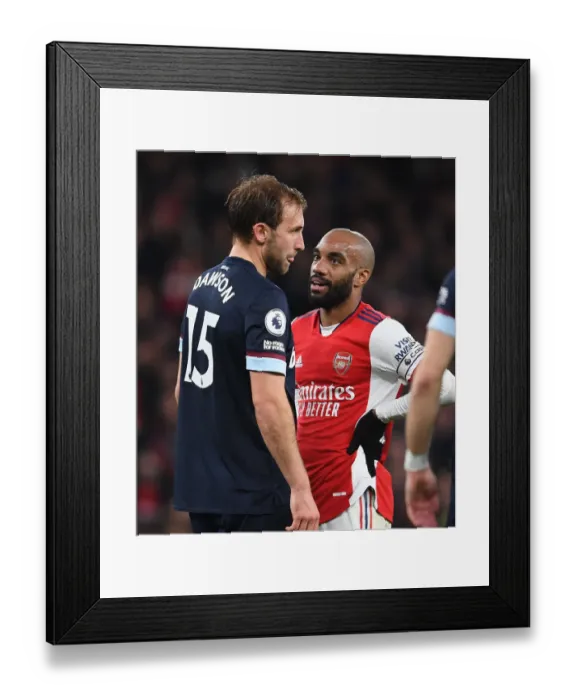 Framed Print : Intense Clash: Lacazette vs. Dawson in Arsenal's Battle Against West Ham United