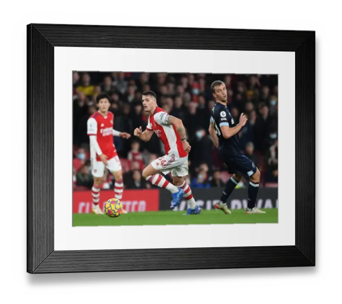 Framed Print : Granit Xhaka Surges Past West Ham's Alex Kral in Arsenal's Premier League Clash