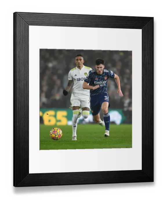 Framed Print : Arsenal's Kieran Tierney Outmaneuvers Leeds Raphinha in Premier League Clash Framed Print : Arsenal's Kieran Tierney Outmaneuvers Leeds Raphinha in Premier League Clash