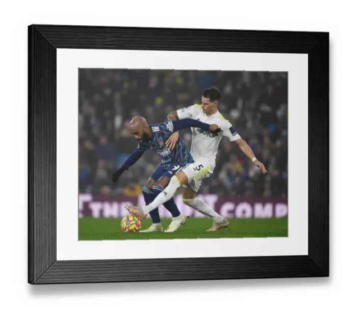 Framed Print : Lacazette vs. Koch: A Premier League Battle - Leeds United vs. Arsenal