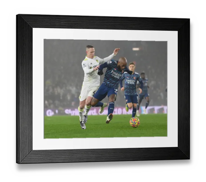 Framed Print : Lacazette vs. Forshaw: A Football Rivalry Ignites in Leeds United vs. Arsenal Clash