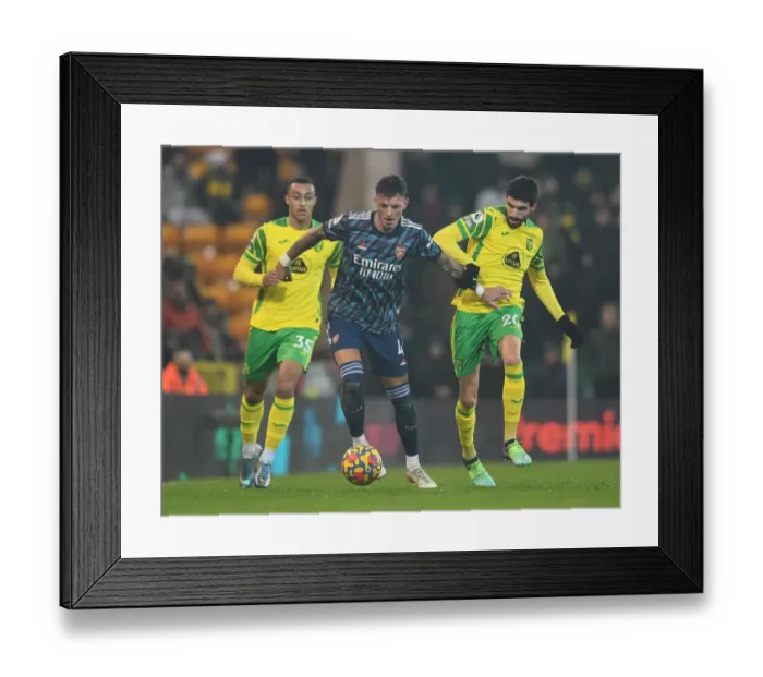Framed Print : Arsenal's Ben White vs. Norwich's Pierre-Lees Melou: A Premier League Battle at Carrow Road (Norwich City vs. Arsenal 2021-22)