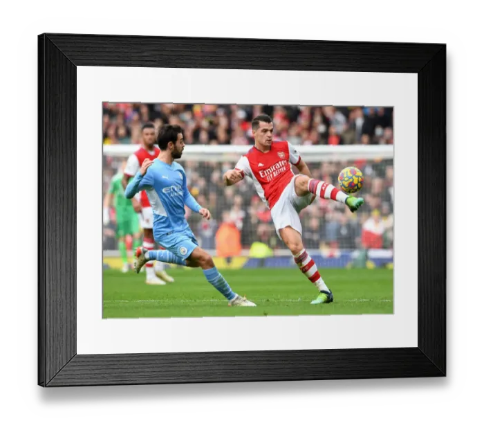 Framed Print : Arsenal's Xhaka Fends Off Manchester City's Silva: Premier League Clash at Emirates Stadium (January 2022) Framed Print : Arsenal's Xhaka Fends Off Manchester City's Silva: Premier League Clash at Emirates Stadium (January 2022)
