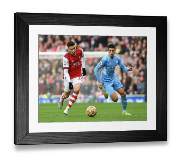 Framed Print : Arsenal's Martinelli Clashes with Manchester City's Cancelo in Premier League Showdown Framed Print : Arsenal's Martinelli Clashes with Manchester City's Cancelo in Premier League Showdown