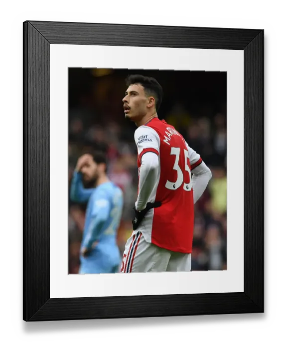 Framed Print : Martinelli's Battle: Arsenal Forward Takes on Manchester City in Premier League Clash