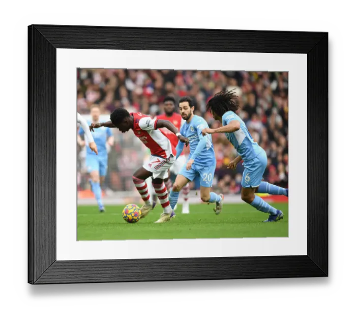 Framed Print : Arsenal's Bukayo Saka Outmaneuvers Manchester City's Nathan Ake in Premier League Clash Framed Print : Arsenal's Bukayo Saka Outmaneuvers Manchester City's Nathan Ake in Premier League Clash