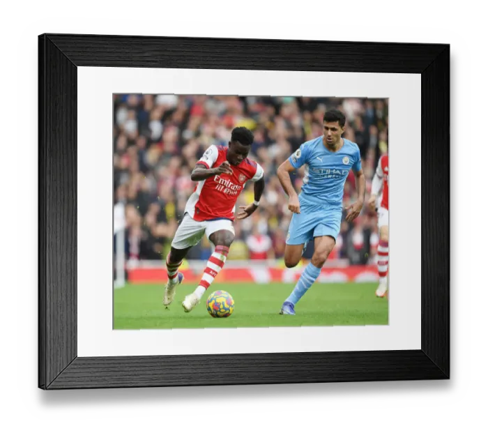 Framed Print : Arsenal's Bukayo Saka Takes on Rodri in Intense Arsenal v Manchester City Clash (Premier League 2021-22)