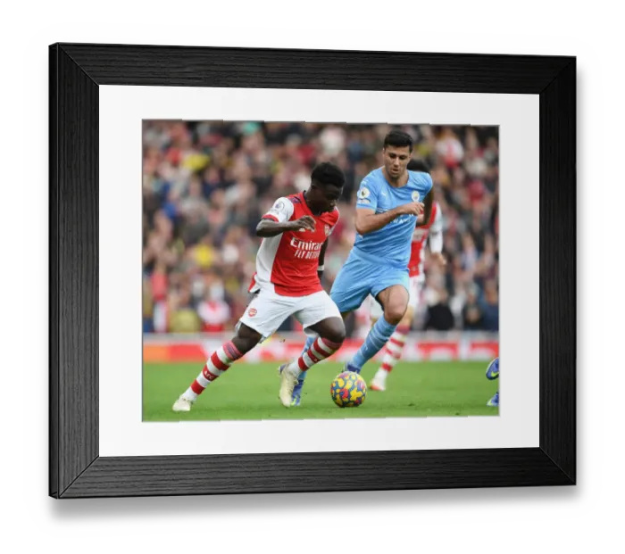 Framed Print : Bukayo Saka vs. Rodri: Intense Showdown in Arsenal vs. Manchester City Clash