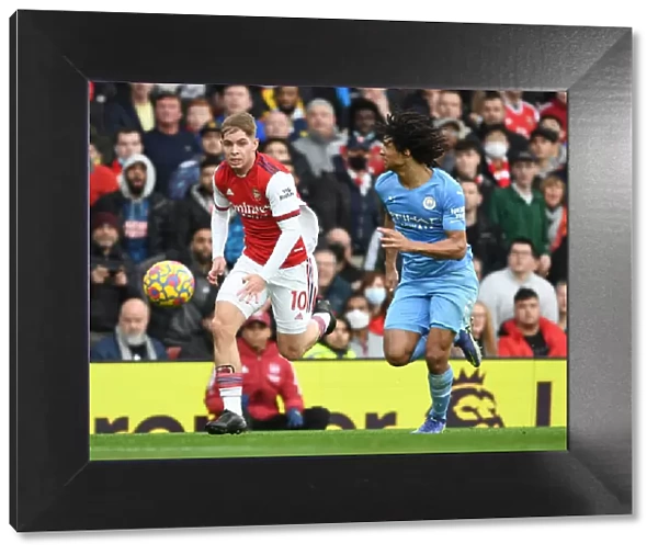 Arsenal's Emile Smith Rowe Outmaneuvers Manchester City's Nathan Ake in Premier League Clash