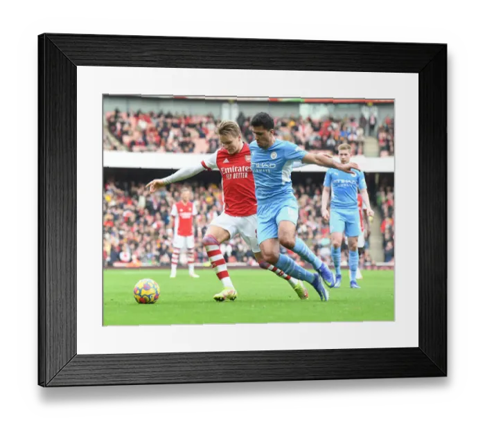 Framed Print : Arsenal's Martin Odegaard Clashes with Manchester City's Rodri: A Premier League Showdown at Emirates Stadium