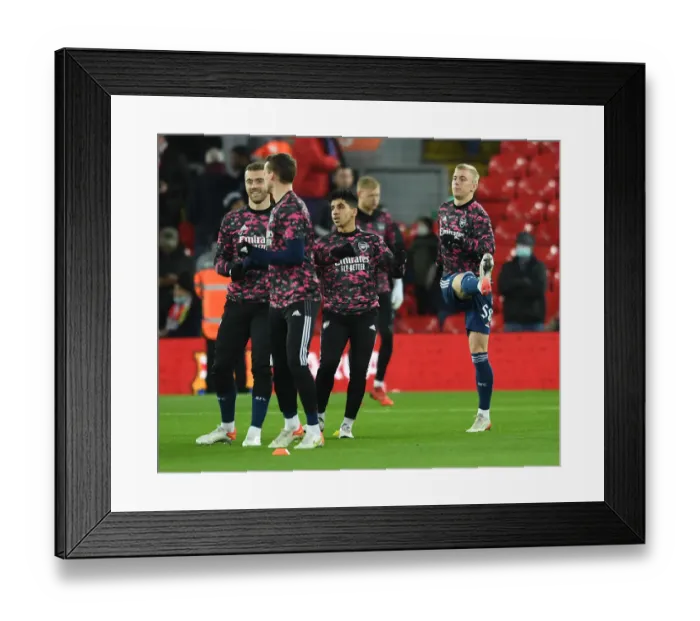 Framed Print : Arsenal and Liverpool Players Warm Up Ahead of Carabao Cup Semi-Final Clash