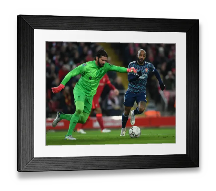 Framed Print : Lacazette vs Alisson: Intense Clash in Carabao Cup Semi-Final First Leg between Liverpool and Arsenal