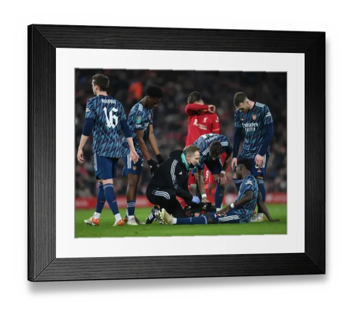 Framed Print : Arsenal's Bukayo Saka Receives Treatment from Physio During Liverpool vs Arsenal Carabao Cup Semi-Final