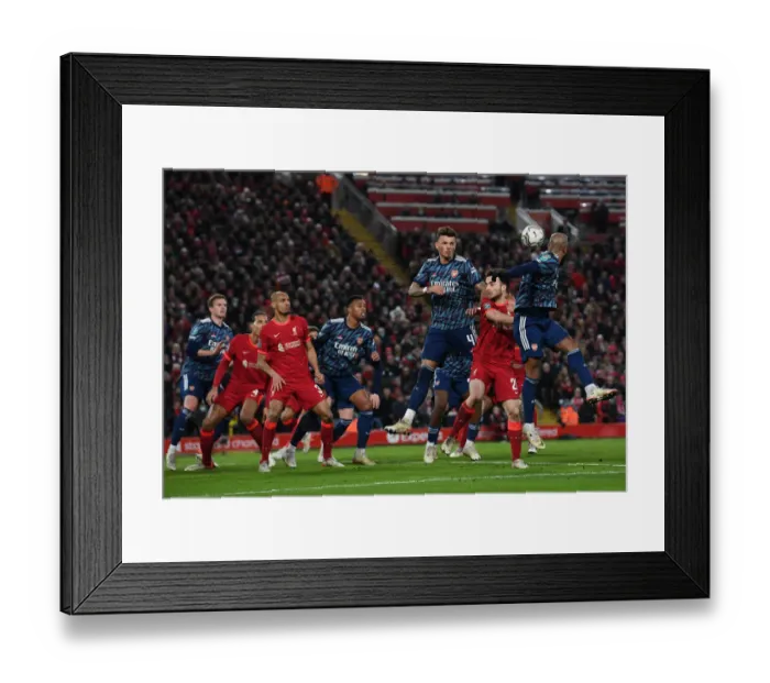 Framed Print : Arsenal's Ben White Braves Heading Duel in Carabao Cup Semi-Final Clash vs. Liverpool