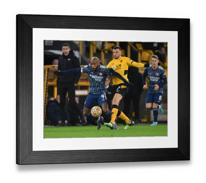 Framed Print : Wolverhampton Wanderers vs. Arsenal: Lacazette Tripped by Saiss in Intense Premier League Clash